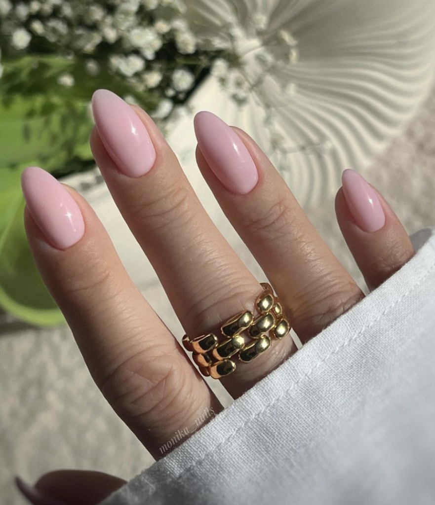 Close-up of nails with a soft pink base.
